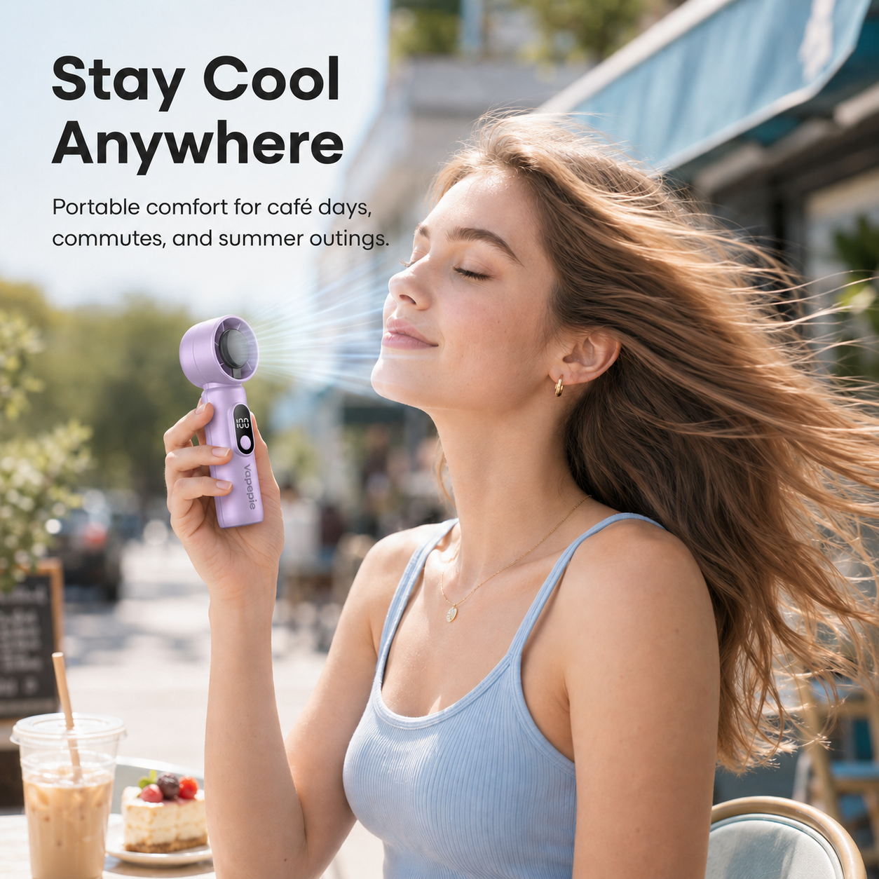 Lilac portable mini fan used outdoors on a summer café day